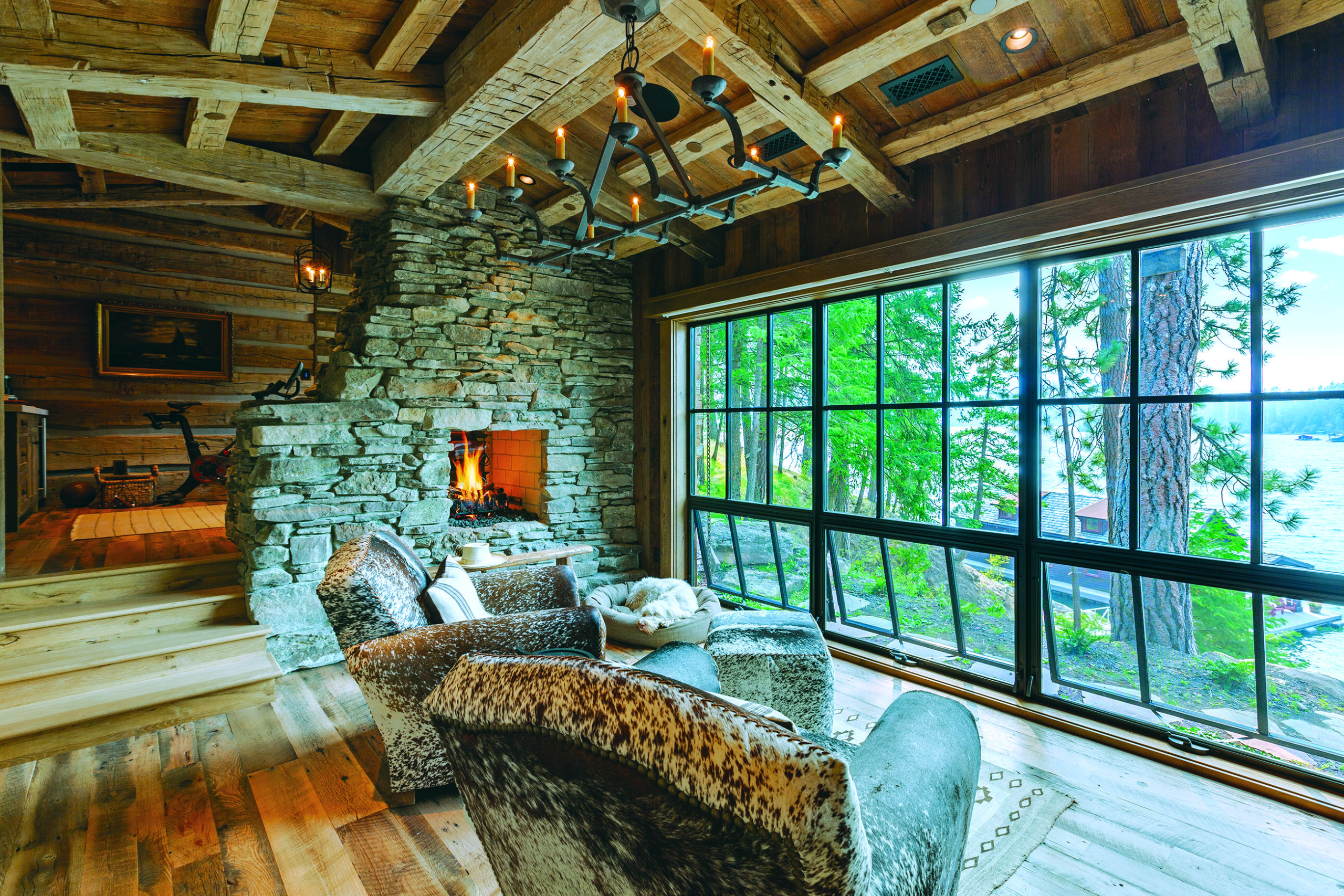 The sitting area in the primary bedroom cabin makes use of vintage armchairs repurposed from the original cottage and re-upholstered in hair-on hide.