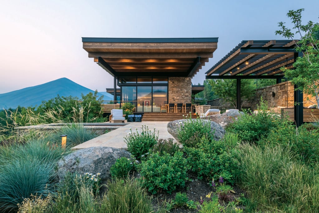 Thanks to impeccable architectural elements—including a large overhang and doors that fold all the way back—a lush landscape, exceptional views and an abundance of stylish furnishings, this home affords its owners the ultimate indoor-outdoor living experience. | Photo: Audrey Hall