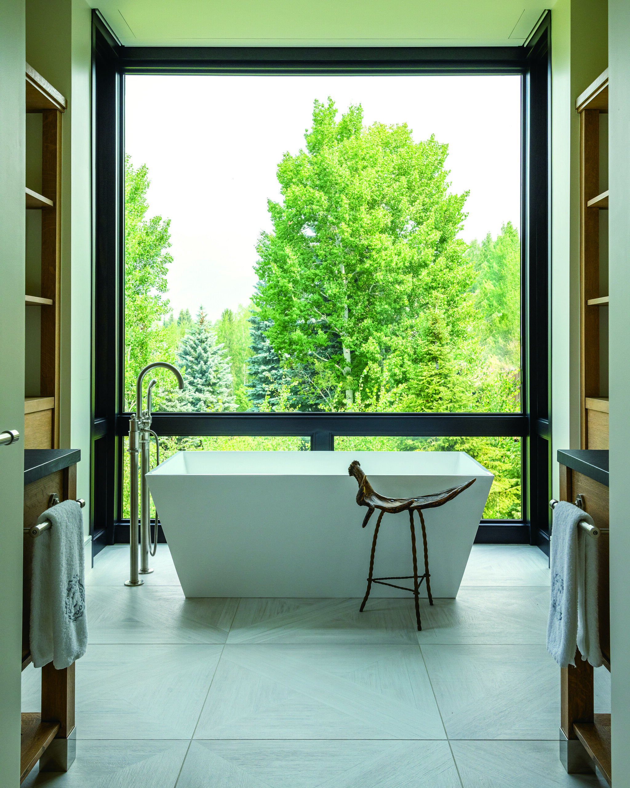 There’s nothing quitelike a relaxing soak in the freestanding Petra bathtub by MTI while taking in the serene surroundings from a floor-to-ceiling window in the primary bath. |