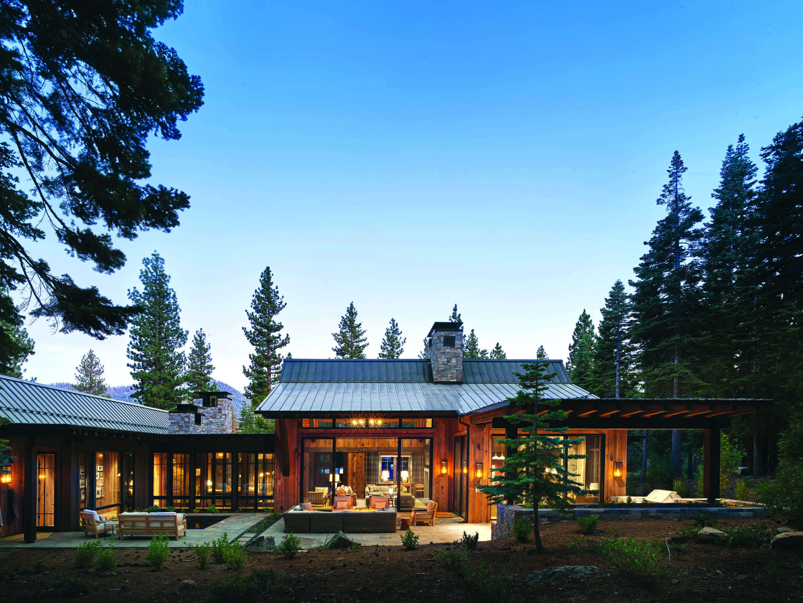 The home is oriented to interact with the wooded property with views out to the trees. “It’s a retreat, and the homeowners come here to celebrate being outside,” says architect Clare Walton. | Photo: Paul Dyer